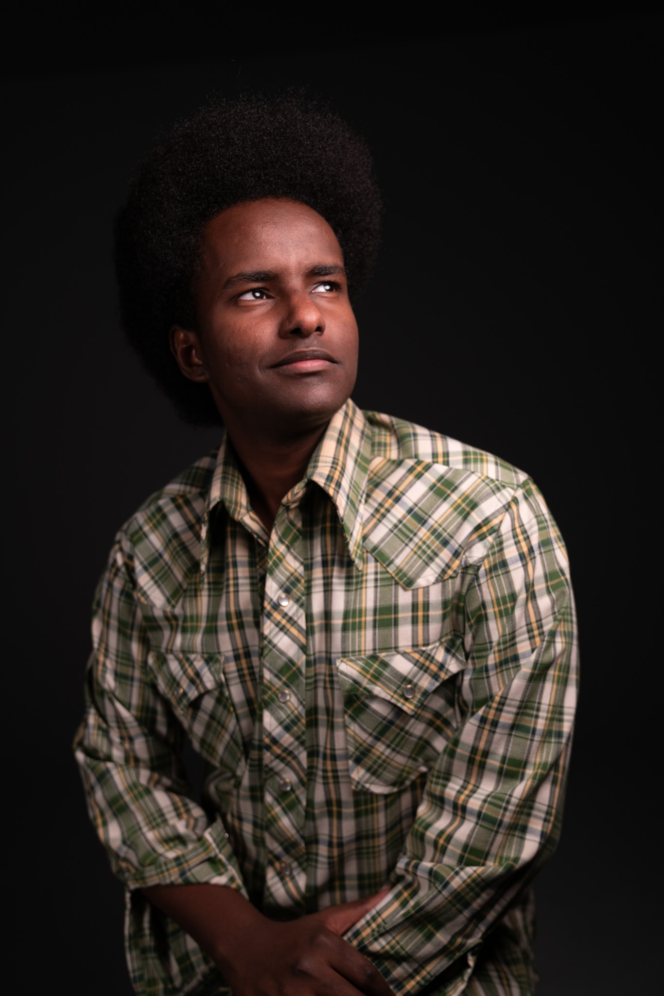 Portrait of Anas, a Minneapolis entrepreneur, looking toward the camera
